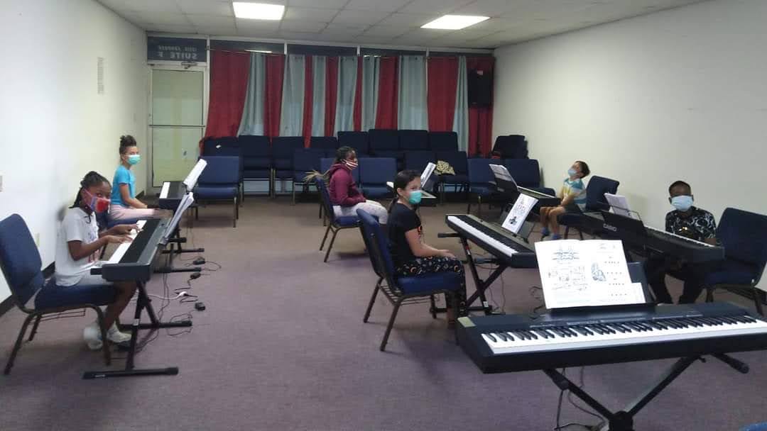 Expert piano instructor teaching a student